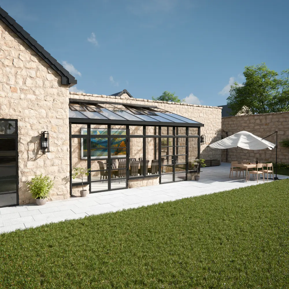 Sheerline S3 aluminium roof system on modern glazed extension with slim black frames and stone property